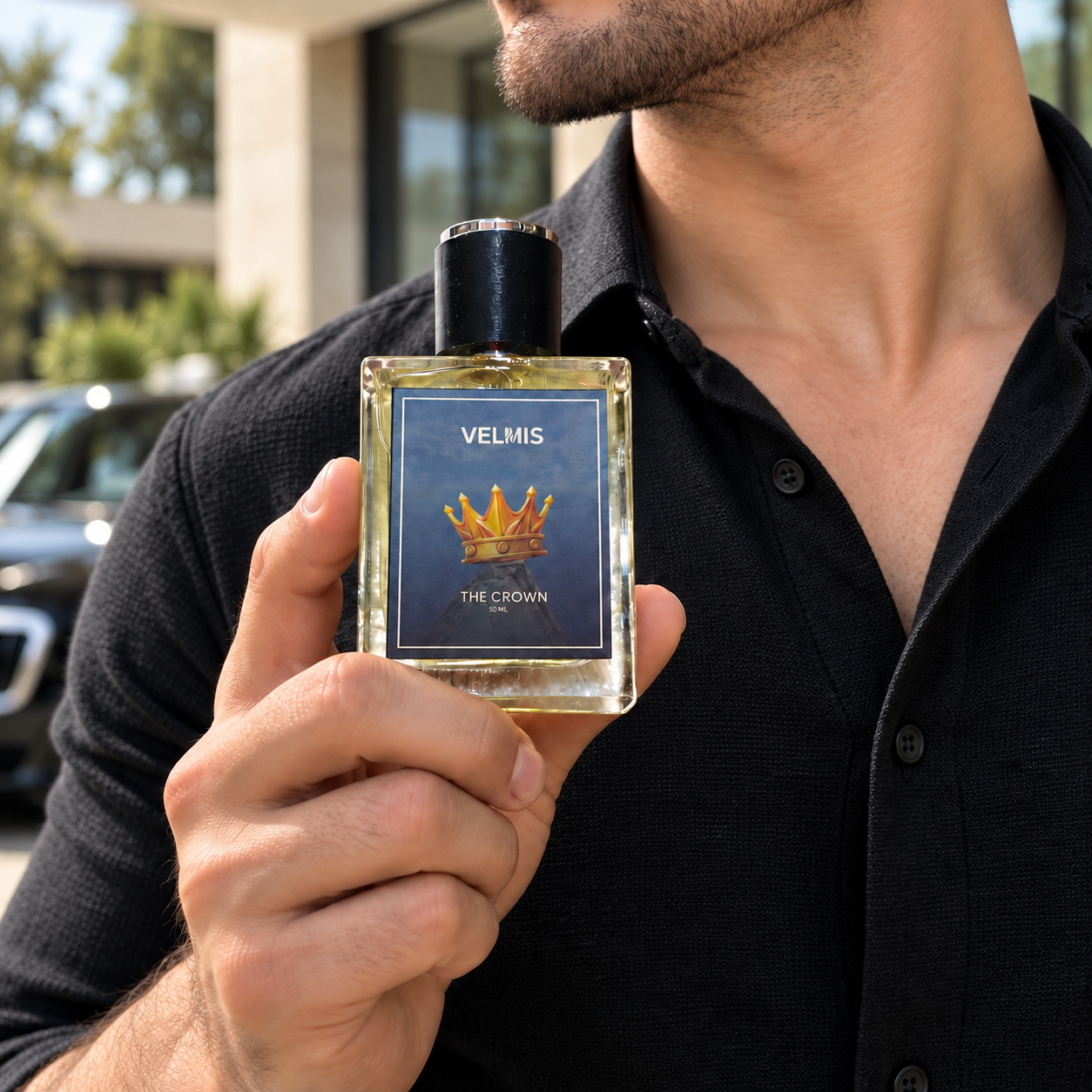 The Crown men's perfume held by man by Velmis